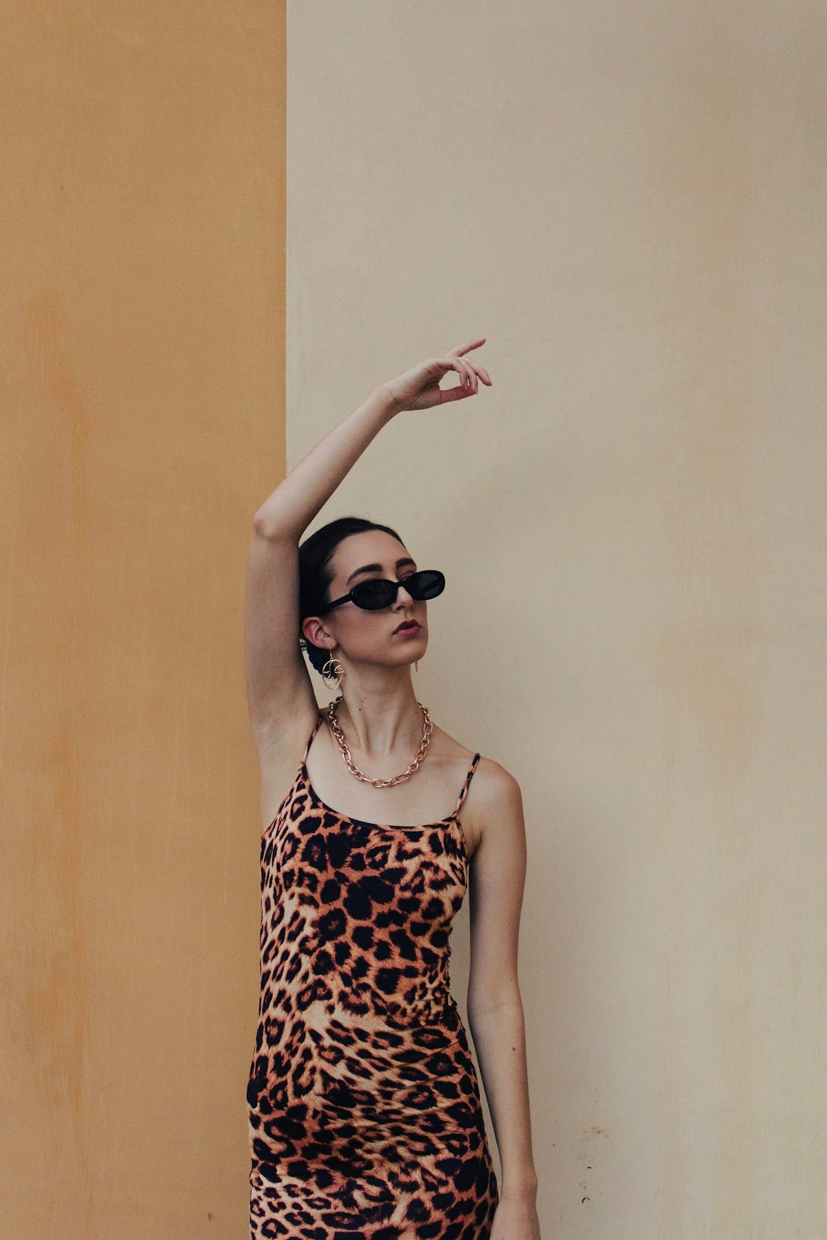 woman in black and white polka dot tank top wearing black sunglasses
