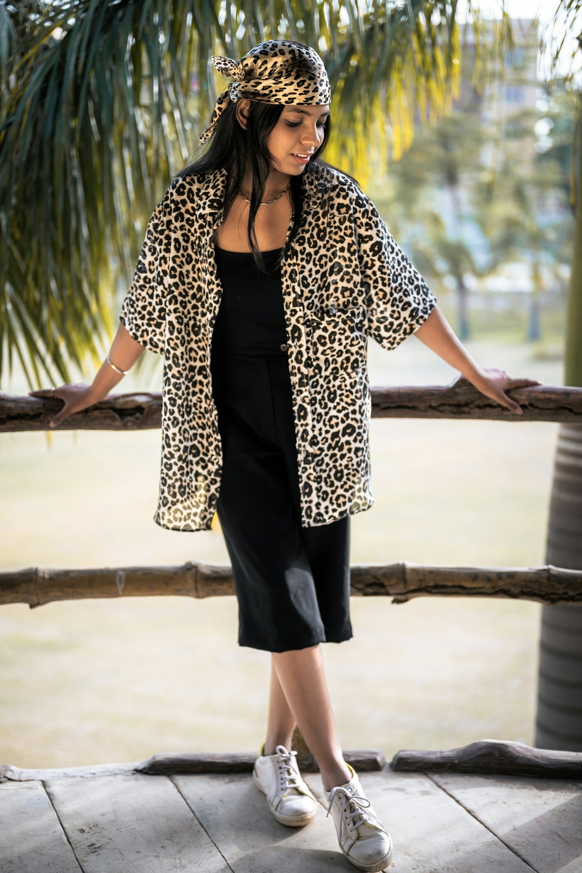 A woman wearing a leopard print jacket and black dress