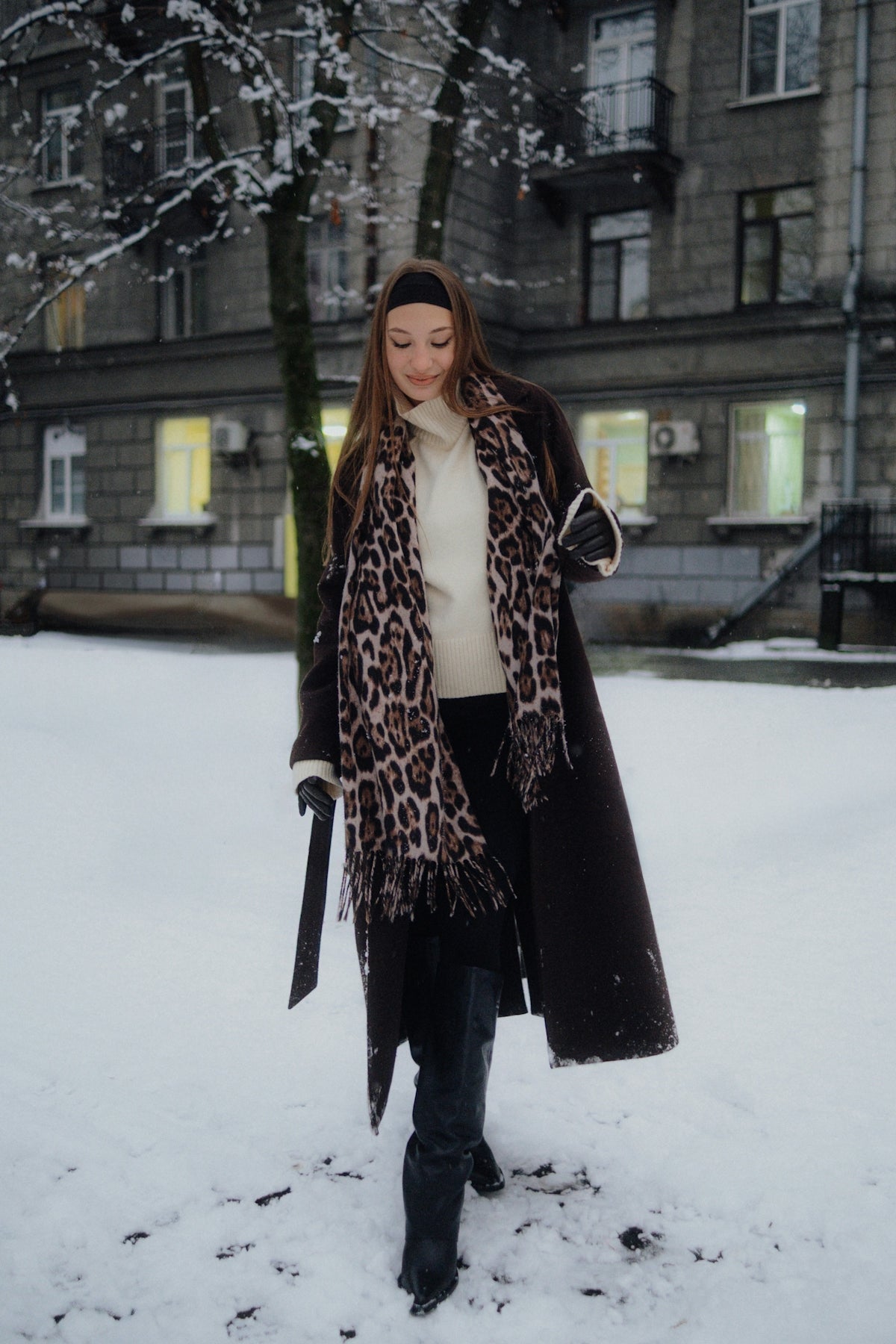 Woman in winter coat walks in snowy park