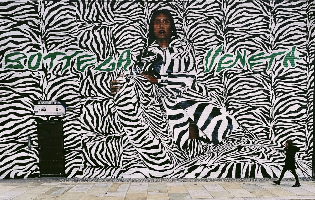 a man standing in front of a zebra print wall