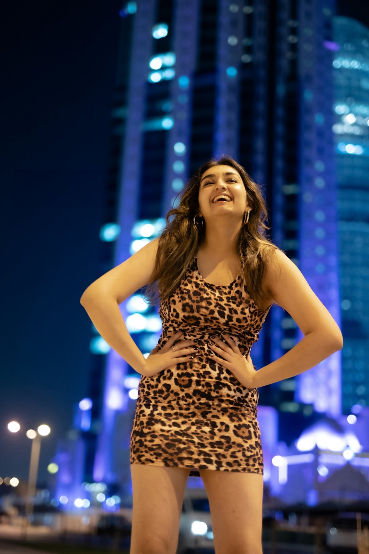 A woman standing in front of a tall building