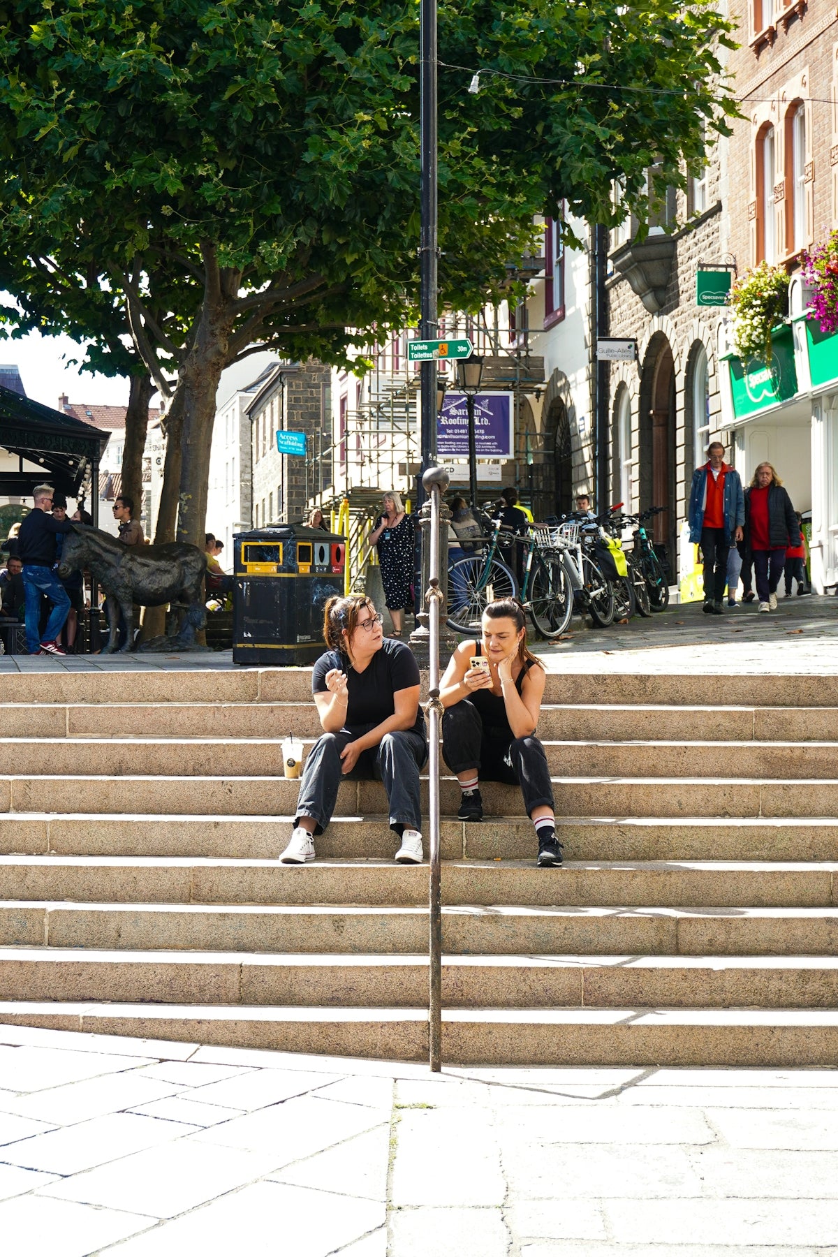 A couple of people sitting on some steps